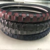 A medium-sized car steering wheel cover with a concave-convex texture made of leather details Picture